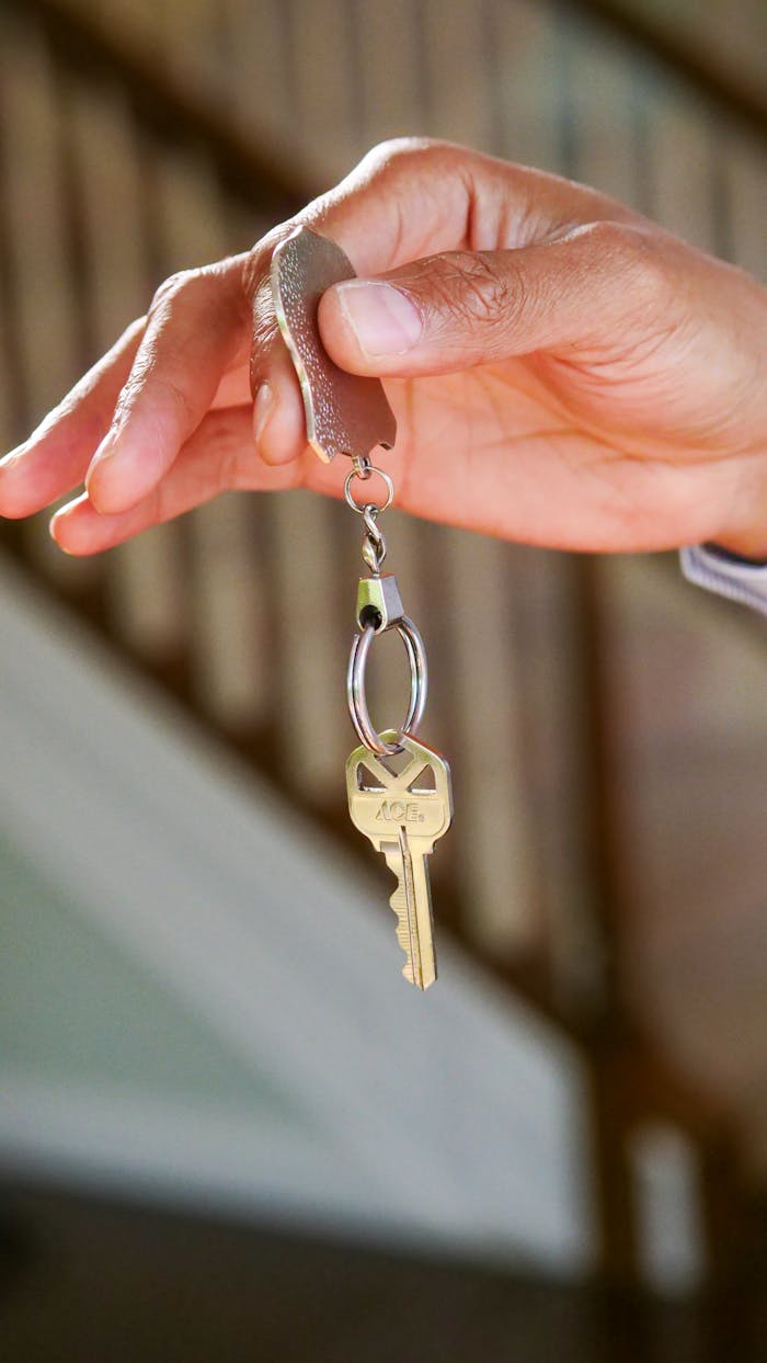 about-us-01 Close-up of a hand holding a key, symbolizing new homeownership or rental.